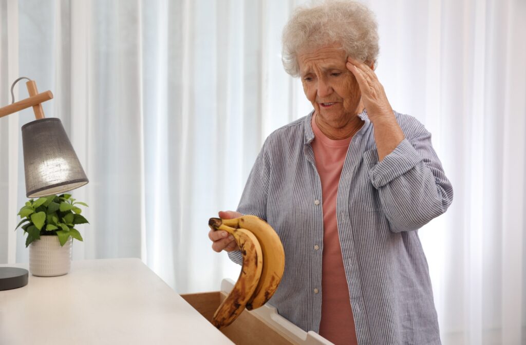 A confused senior finds a pair of aging bananas in their bedroom dresser drawer